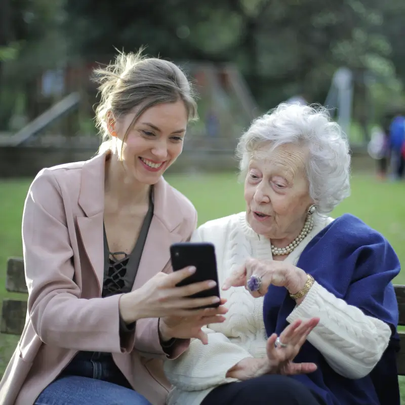 Lady helping elder women on her phone